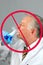 Closeup of a mad scientist as he drinks a smoking concoction from a beaker, with International No Symbol. - Do Not Drink