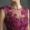 A closeup of a magenta dress with an overlay of floral appliques. Trendy color of 2023 Viva Magenta.. AI generation