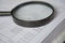 Closeup magnifying glass with finance business sheet