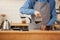 Closeup of male barista hands pouring alternative coffee from chemex.