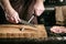 Closeup of male chef hands sharpen a big chef`s knife