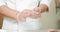 Closeup male cook hands in gloves cooking sushi rolls with rice and salmon in the kitchen.