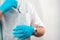 Closeup of a male dentist putting his working glasses in his uniform\'s pocket