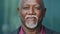 Closeup male face. Elderly African American with gray beard smiles good-natured, nods his head, adult mature person