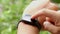 Closeup male finger interacting with wearing technology smartwatch outdoor video 4k