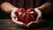 closeup male hands holding gift heart shaped box with red bow