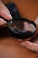 Closeup of male hands holding magnifier and diode