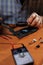 Closeup of male hands soldering computer board