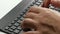 Closeup male hands typing on bluetooth keyboard