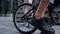 Closeup male legs pedaling riding shared bicycle. Modern city transportation.