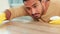 Closeup of a male sanitizing a surface and doing chores. A cleaner busy with housework for a neat, tidy and hygienic