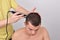 Closeup of a male student having a haircut with hair clippers