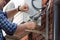 Closeup of male technician repairing outdoor air conditioner uni