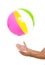 Closeup on males hand throwing beach ball up