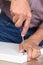 Closeup of a man assembling a DIY piece of furniture. Person is using a screwdriver inserting a piece of hardware