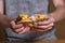 Closeup of a man cutting a cheeseburger by hand