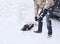 Closeup of man digging snow with shovel near car