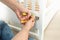 Closeup of man disassembling white wooden bed