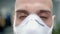 Closeup of man doctor in ppe mask portrait on blurred background of hospital