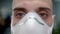Closeup of man doctor in ppe mask portrait on blurred background of hospital