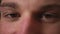 Closeup of man eyes, man has beautiful brown Eyes. Natural Beauty. Man smiling. Slow motion.