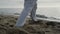 Closeup man feet stepping on sand training karate. Athlete exercising on beach.