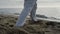 Closeup man feet stepping on sand training karate. Athlete exercising on beach.