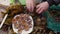 Closeup Man Hand With A Knife Cuts A Sea Urchin In Half And Puts It On A Plate