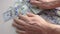 Closeup man hands counting one hundred dollar paper banknotes.