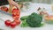 Closeup man hands cutting red pepper with sharp knife in slow motion.