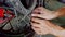 Closeup man hands fasten detail to tire disk in shop