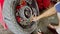 Closeup man hands inflate scooter wheel tire in shop