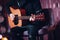 Closeup of a man hands strumming acoustic guitar