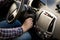 Closeup of man inserting key in car ignition lock