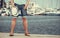 Closeup of man legs on pier in port with yachts.