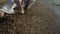 Closeup man legs stretching on wet sand. Fighter squat doing workout on nature.