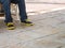 Closeup man legs wear blue jeans pants and sneakers shoes space