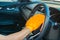 Closeup for man polishing cleaning car steering wheel with microfiber cloth