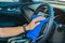 Closeup for man polishing cleaning car steering wheel with microfiber cloth