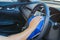 Closeup for man polishing cleaning car steering wheel with microfiber cloth