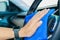 Closeup for man polishing cleaning car steering wheel with microfiber cloth