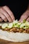 closeup of a man preparing a durum or a burrito