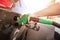 Closeup of man pumping gasoline fuel in car at gas station