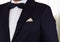 Closeup man\'s chest area wearing formal suit and bowtie, men getting dressed concept