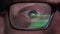Closeup man\'s eyes in glasses works on laptop at night