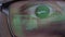 Closeup man\'s eyes in glasses works on laptop at night