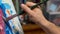 Closeup of man`s hand painting an acrylic or oil abstract picture o