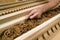 Closeup of a man`s hand sanding woodwork.