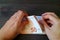 Closeup Man`s Hands Counting 50 EURO Banknotes on Dark Color Wooden Table