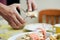 Closeup of man\'s hands cracking lobster above dish